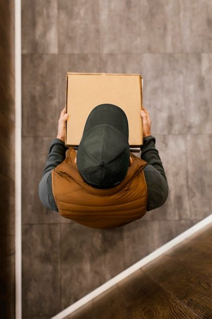 Courier carrying a sealed package to its final destination